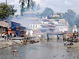 Kathmandu Pashupatinath 08 Pashupatinath Burning Ghats From Down The Bagmati River I walked south on the side of the Bagmati River and looked back from a bridge, with the Pashupatinath temple complex and burning ghats on the left side of the river.